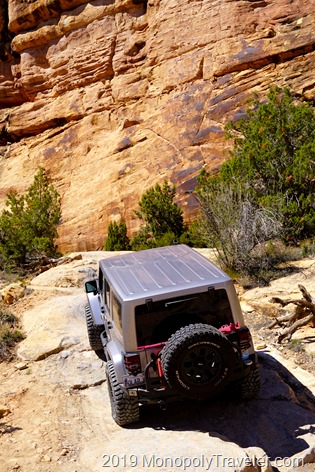 Climbing some rock ledges with the Jeep near steep canyon walls