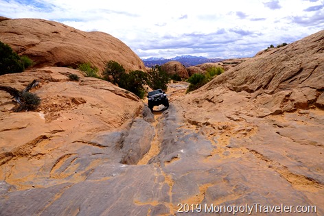 Tires barely gripping the slick rock as we climb up